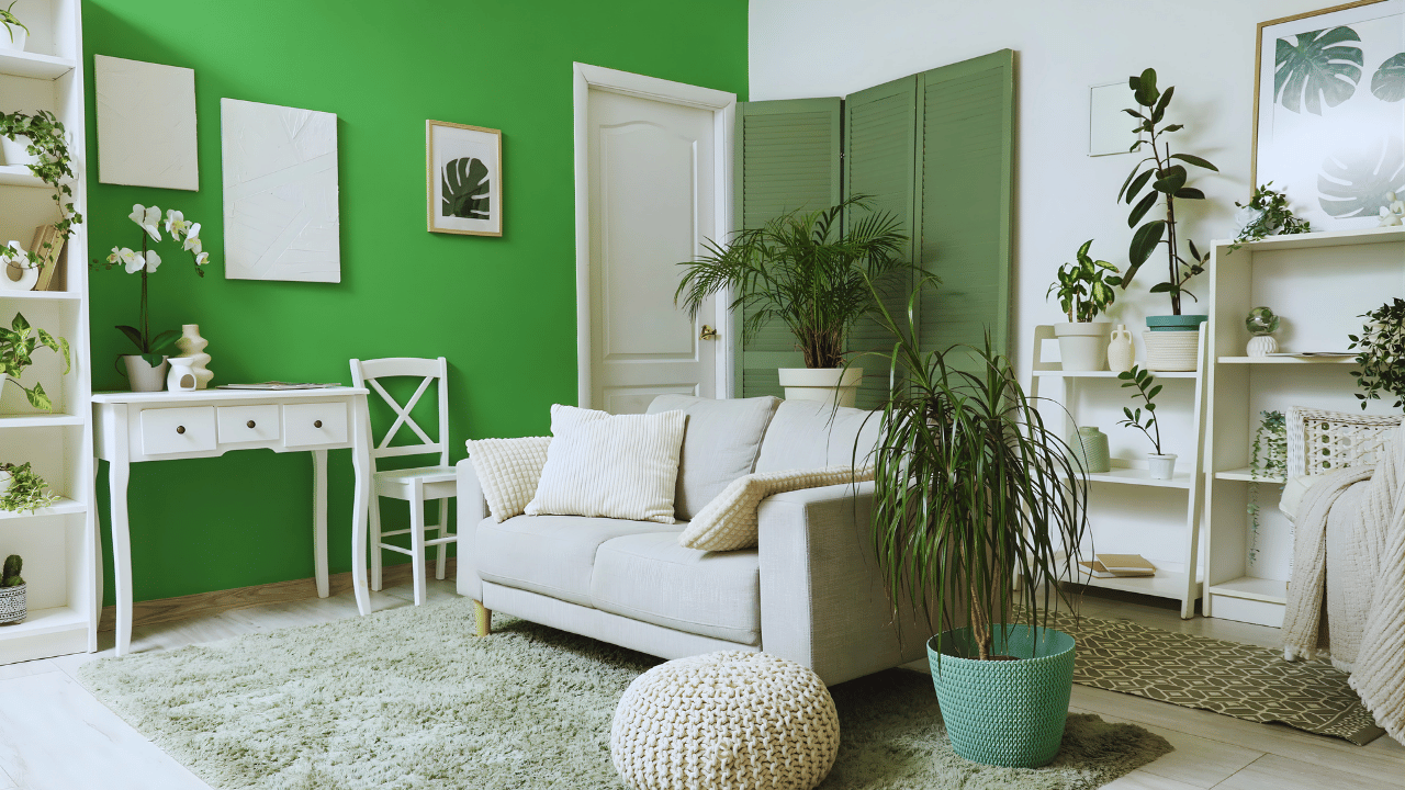 Modern living room decorated with green accents including cushions, plants, and wall decor for a fresh interior design look