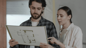 Home renovation budgeting concept showing calculator, house plans, and cost estimation tools for construction planning