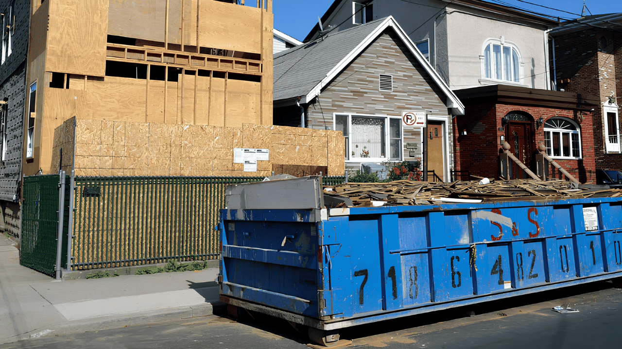 Large dumpster container placed at a construction site for waste disposal during home renovation cleanup