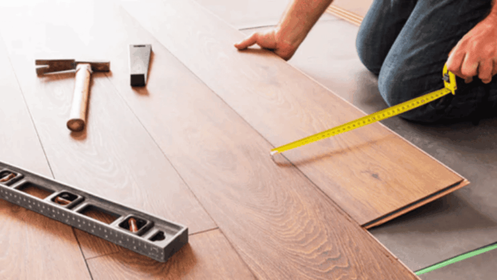 Flood-damaged home interior showing water-damaged hardwood floors and restoration process to repair and recover living space