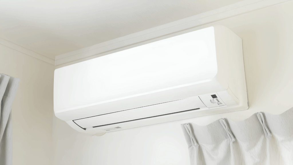 Person using a smartphone to control an air conditioner through the Orient AC Remote mobile app for smart home temperature management.