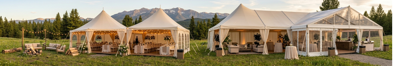 White outdoor event tent with table and chairs on a landscaped garden lawn